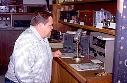 A visitor to ARRL HQ, Dave Brindle, K1WER, of Nashua, New Hampshire, checks out another vintage station in K2TQN's Old Radio Museum. The station includes a Stancor transmitter and a Silvertone receiver.