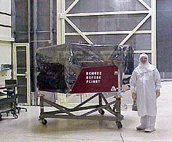 Integration Lab Manager Lou McFadin, W5DID, stands next to the Phase 3D satellite--under wraps, and awaiting its turn for vibration testing at the large RF chamber clean room at Goddard Space Flight Center. [Courtesy of Lou McFadin, W5DID]